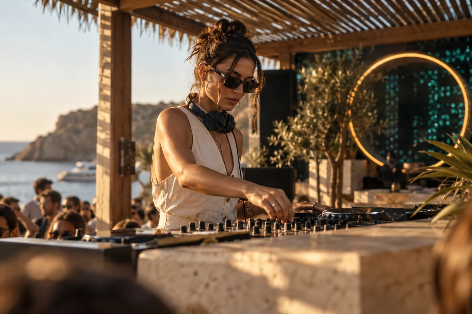 A DJ playing a sunset set overlooking the sea — fictional demo venue